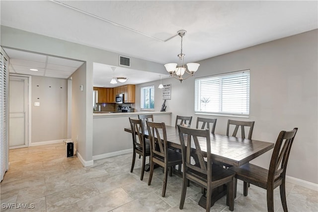2100 Barkeley Ln Unit 1, Fort Myers, FL 33907 - dining room with a chandelier and baseboards