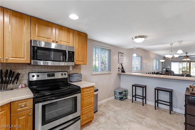 2100 Barkeley Ln Unit 1, Fort Myers, FL 33907 - kitchen featuring appliances with stainless steel finishes, tasteful backsplash, and plenty of natural light