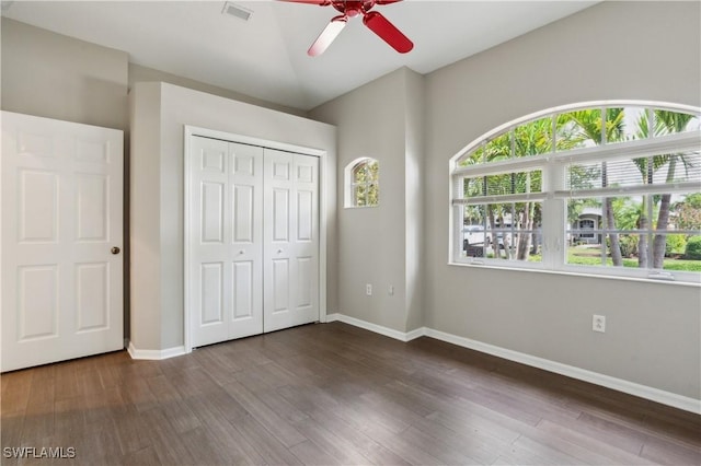 12642 Cara Cara Loop, Bradenton, FL 34212 - unfurnished bedroom with dark wood-style flooring, baseboards, a closet, and a ceiling fan