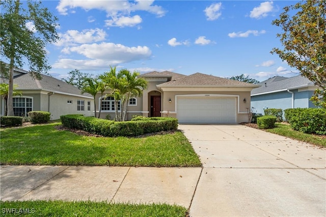 12642 Cara Cara Loop, Bradenton, FL 34212 - view of front of property featuring stucco siding, a garage, driveway, and a front yard