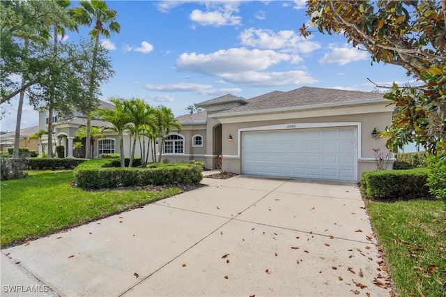 12642 Cara Cara Loop, Bradenton, FL 34212 - view of front of home with stucco siding, driveway, a garage, and a front lawn