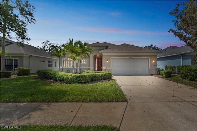 12642 Cara Cara Loop, Bradenton, FL 34212 - ranch-style home featuring stucco siding, a garage, driveway, and a front lawn