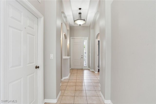 12642 Cara Cara Loop, Bradenton, FL 34212 - hallway with light tile patterned flooring, baseboards, and arched walkways
