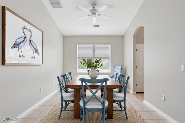 12642 Cara Cara Loop, Bradenton, FL 34212 - dining area with arched walkways, a ceiling fan, light tile patterned floors, and baseboards