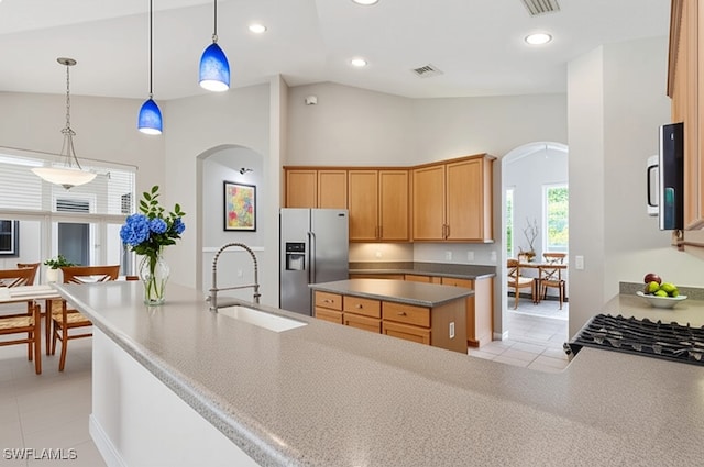 12642 Cara Cara Loop, Bradenton, FL 34212 - kitchen with stainless steel fridge, arched walkways, a sink, light tile patterned floors, and recessed lighting