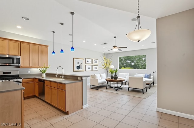 12642 Cara Cara Loop, Bradenton, FL 34212 - kitchen with stainless steel appliances, open floor plan, a sink, a peninsula, and ceiling fan