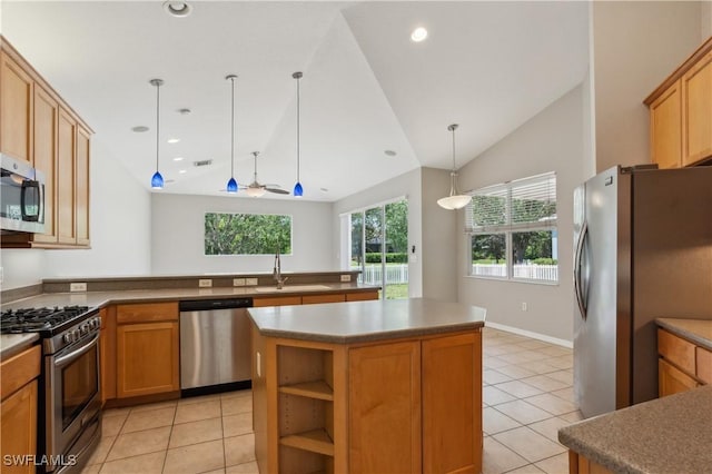 12642 Cara Cara Loop, Bradenton, FL 34212 - kitchen featuring appliances with stainless steel finishes, a sink, light tile patterned floors, lofted ceiling, and a center island