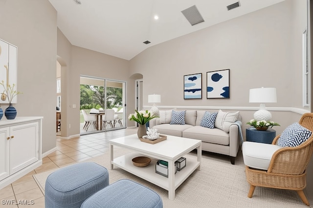 12642 Cara Cara Loop, Bradenton, FL 34212 - living area with arched walkways, high vaulted ceiling, light tile patterned floors, and baseboards
