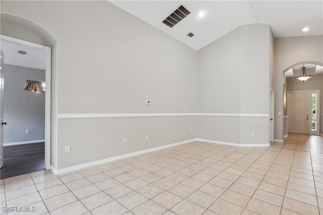 12642 Cara Cara Loop, Bradenton, FL 34212 - spare room with arched walkways, light tile patterned flooring, high vaulted ceiling, baseboards, and recessed lighting