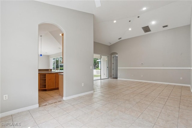 12642 Cara Cara Loop, Bradenton, FL 34212 - spare room featuring arched walkways, light tile patterned floors, lofted ceiling, recessed lighting, and baseboards