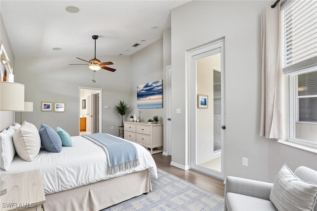 12642 Cara Cara Loop, Bradenton, FL 34212 - bedroom with wood finished floors, ensuite bath, vaulted ceiling, baseboards, and a ceiling fan