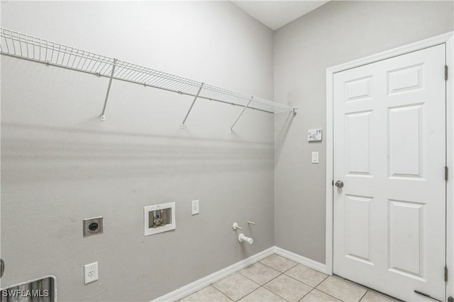 12642 Cara Cara Loop, Bradenton, FL 34212 - laundry room featuring washer hookup, light tile patterned floors, baseboards, electric dryer hookup, and hookup for a gas dryer