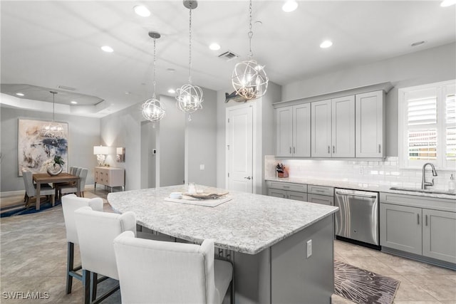 8761 Bellano Ct Unit 202, Naples, FL 34119 - kitchen with dishwasher, a sink, recessed lighting, gray cabinets, and a center island