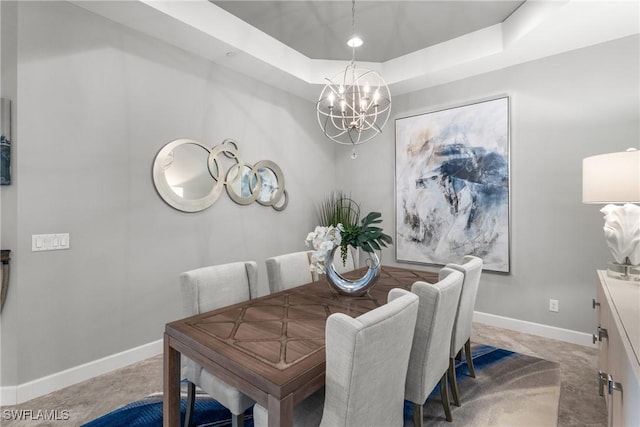 8761 Bellano Ct Unit 202, Naples, FL 34119 - dining space featuring a chandelier, baseboards, and a raised ceiling