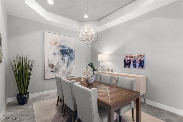 8761 Bellano Ct Unit 202, Naples, FL 34119 - dining room featuring a chandelier, baseboards, a tray ceiling, and recessed lighting