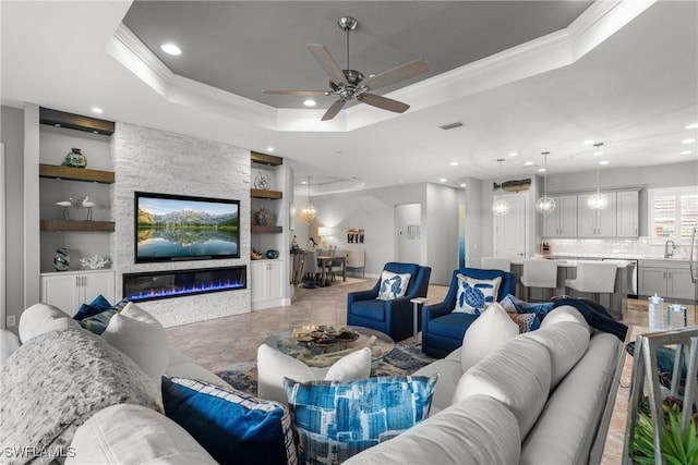 8761 Bellano Ct Unit 202, Naples, FL 34119 - living area featuring built in features, ornamental molding, recessed lighting, a tray ceiling, and ceiling fan