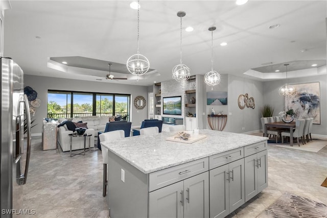 8761 Bellano Ct Unit 202, Naples, FL 34119 - kitchen featuring a tray ceiling, recessed lighting, a chandelier, open floor plan, and a ceiling fan
