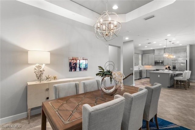 8761 Bellano Ct Unit 202, Naples, FL 34119 - dining area featuring a chandelier, baseboards, and recessed lighting