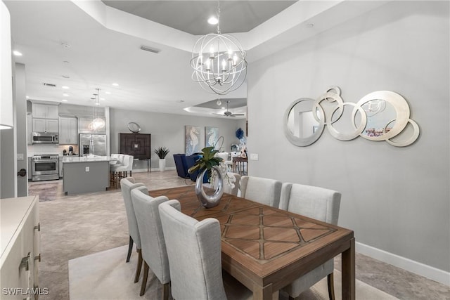 8761 Bellano Ct Unit 202, Naples, FL 34119 - dining area featuring a chandelier, baseboards, a raised ceiling, and recessed lighting