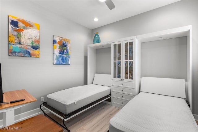 8761 Bellano Ct Unit 202, Naples, FL 34119 - bedroom with light wood-type flooring, recessed lighting, ceiling fan, and baseboards