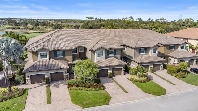 8761 Bellano Ct Unit 202, Naples, FL 34119 - mediterranean / spanish-style home with stucco siding, a tile roof, driveway, a residential view, and a garage
