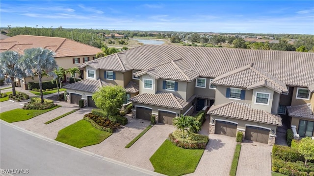 8761 Bellano Ct Unit 202, Naples, FL 34119 - mediterranean / spanish-style house featuring stucco siding, a residential view, and an attached garage