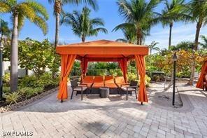 8761 Bellano Ct Unit 202, Naples, FL 34119 - surrounding community featuring a gazebo, an outdoor hangout area, and a patio area