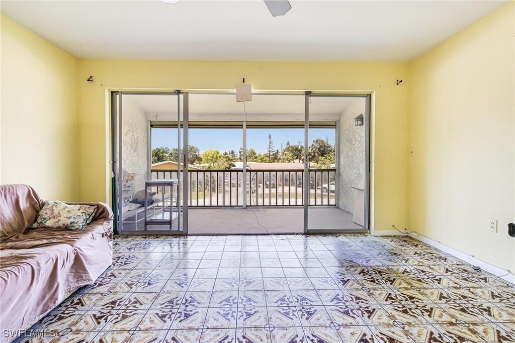 4900 Biscayne Dr Unit 14, Naples, FL 34112 - tiled living area with plenty of natural light