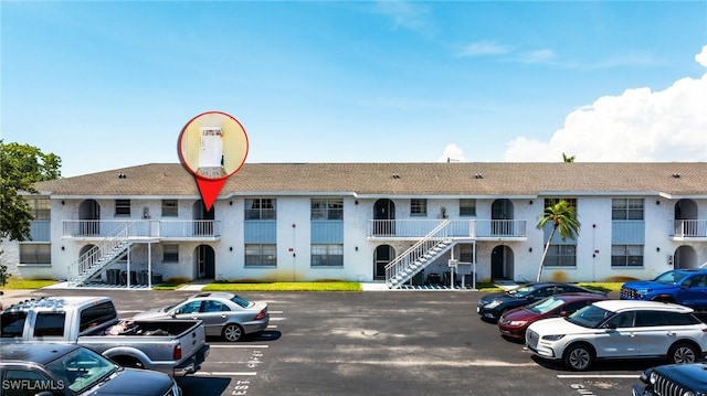 4900 Biscayne Dr Unit 14, Naples, FL 34112 - view of property featuring stairway and uncovered parking