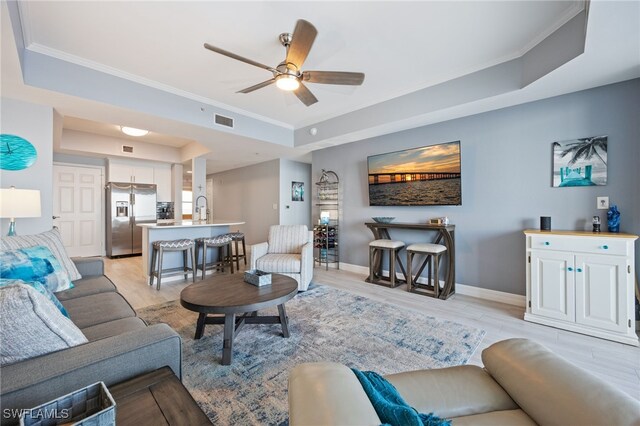 2797 1st St Unit 803, Fort Myers, FL 33916 - living room with a raised ceiling, ornamental molding, ceiling fan, light wood finished floors, and baseboards