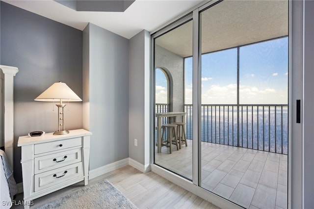 2797 1st St Unit 803, Fort Myers, FL 33916 - doorway featuring expansive windows, baseboards, and light wood-type flooring