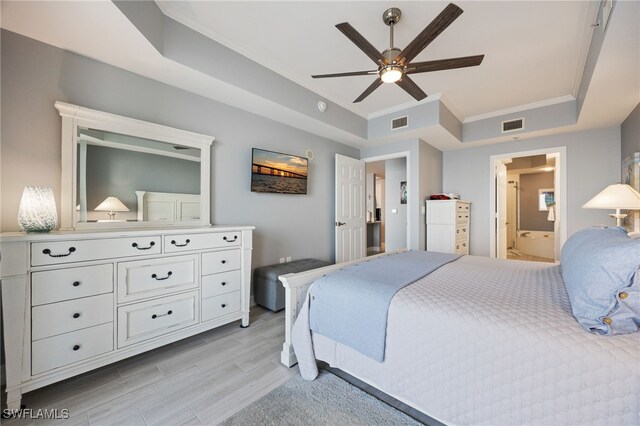 2797 1st St Unit 803, Fort Myers, FL 33916 - bedroom with ornamental molding, light wood finished floors, a raised ceiling, ensuite bath, and ceiling fan
