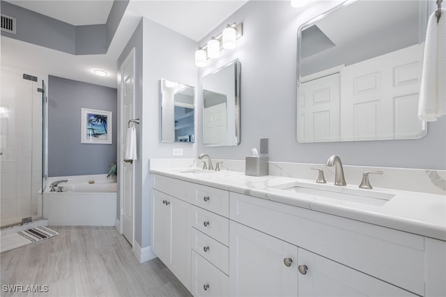 2797 1st St Unit 803, Fort Myers, FL 33916 - full bath featuring a bath, double vanity, a shower stall, and wood finished floors