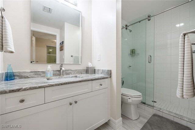 2797 1st St Unit 803, Fort Myers, FL 33916 - bathroom featuring toilet, vanity, and a stall shower