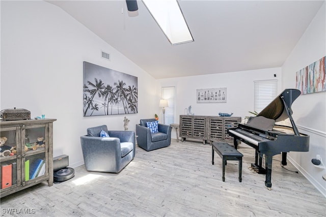 25379 Paladin Ln, Punta Gorda, FL 33983 - living area with vaulted ceiling, wood finished floors, ceiling fan, a skylight, and baseboards