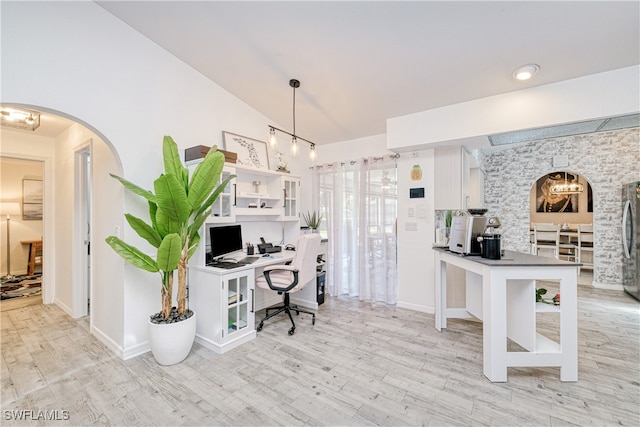25379 Paladin Ln, Punta Gorda, FL 33983 - office featuring light wood-type flooring, arched walkways, lofted ceiling, and baseboards