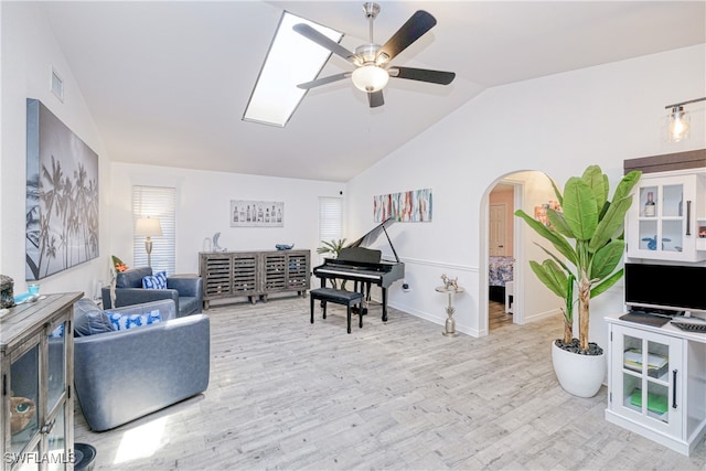 25379 Paladin Ln, Punta Gorda, FL 33983 - living room featuring lofted ceiling, arched walkways, a ceiling fan, wood finished floors, and healthy amount of natural light