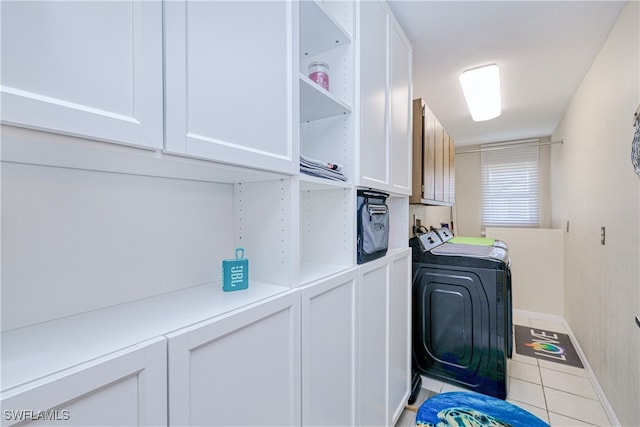 25379 Paladin Ln, Punta Gorda, FL 33983 - laundry area with cabinet space, washer and dryer, light tile patterned floors, and baseboards