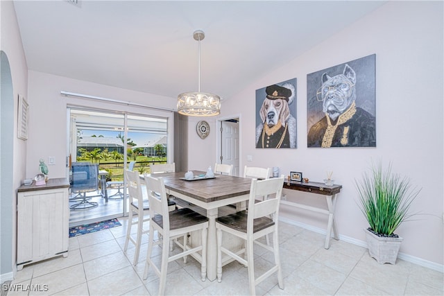 25379 Paladin Ln, Punta Gorda, FL 33983 - dining room with a chandelier, lofted ceiling, light tile patterned floors, and baseboards
