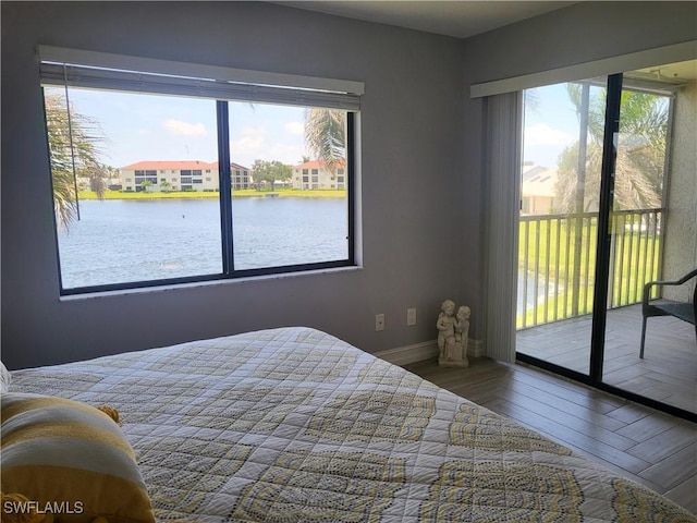 11460 Caravel Cir Unit 5016, Fort Myers, FL 33908 - bedroom with access to outside, multiple windows, wood finished floors, and baseboards