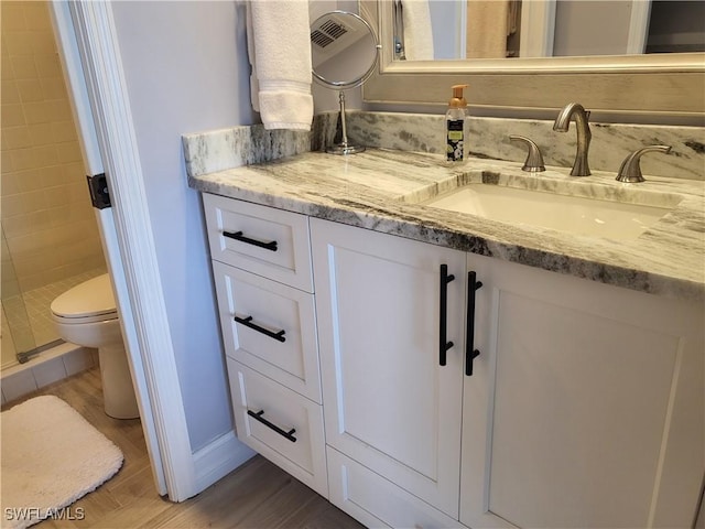 11460 Caravel Cir Unit 5016, Fort Myers, FL 33908 - full bathroom with vanity, wood finished floors, a shower stall, toilet, and baseboards