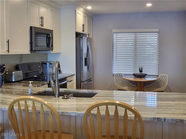 11460 Caravel Cir Unit 5016, Fort Myers, FL 33908 - kitchen featuring stainless steel fridge with ice dispenser, light stone countertops, tasteful backsplash, black electric range, and white cabinetry