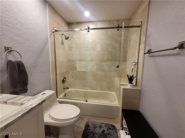 11460 Caravel Cir Unit 5016, Fort Myers, FL 33908 - bathroom featuring vanity, toilet, shower / bath combination with glass door, and a textured wall