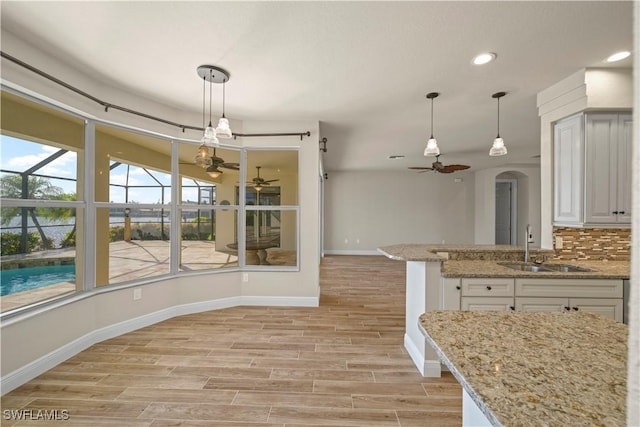 1069 SW 57th St, Cape Coral, FL 33914 - kitchen with a ceiling fan, light wood-style floors, hanging light fixtures, and recessed lighting