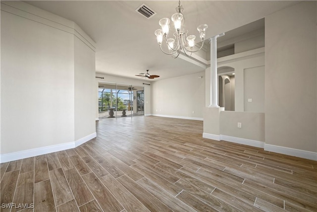 1069 SW 57th St, Cape Coral, FL 33914 - unfurnished living room with wood finished floors, a chandelier, and ceiling fan