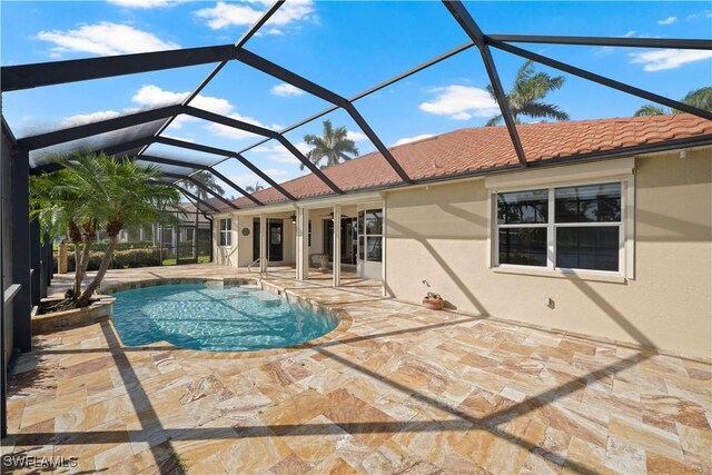 1069 SW 57th St, Cape Coral, FL 33914 - outdoor pool featuring a patio area and glass enclosure