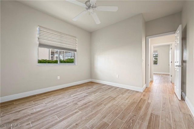 1069 SW 57th St, Cape Coral, FL 33914 - unfurnished room with light wood finished floors, plenty of natural light, and a ceiling fan
