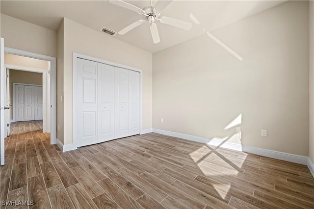 1069 SW 57th St, Cape Coral, FL 33914 - unfurnished bedroom with wood finished floors, a closet, and ceiling fan