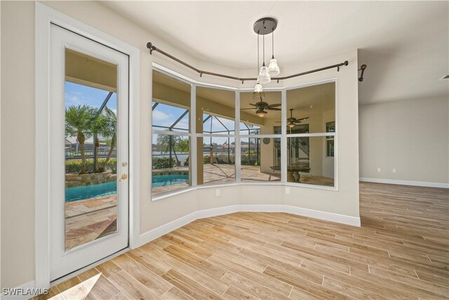1069 SW 57th St, Cape Coral, FL 33914 - spare room with a sunroom, a ceiling fan, and wood finished floors