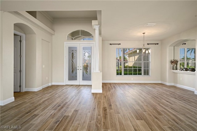 1069 SW 57th St, Cape Coral, FL 33914 - foyer with wood finished floors, french doors, and arched walkways